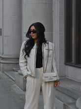 A lady wears a wool-blend tweed jacket.